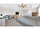 Bright main bedroom featuring a ceiling fan, trey ceiling, and soft carpeting at 3602 W Iowa Ave, Tampa, FL 33611