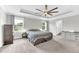 Spacious main bedroom features carpeted floors, a ceiling fan, and lots of windows at 3602 W Iowa Ave, Tampa, FL 33611