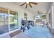 Screened in patio featuring ceiling fans, a grill, and outdoor seating at 3602 W Iowa Ave, Tampa, FL 33611