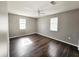 Large bedroom with natural light, ceiling fan and dark hardwood floors at 3615 W Cherry St, Tampa, FL 33607