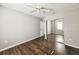 Spacious bedroom featuring a ceiling fan, closet with mirror doors, and hardwood flooring at 3615 W Cherry St, Tampa, FL 33607