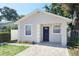 Charming single-story home with a freshly painted exterior, walkway, and neat landscaping at 3615 W Cherry St, Tampa, FL 33607