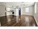 Open living space with combined kitchen and living room, featuring modern appliances and wood floors at 3615 W Cherry St, Tampa, FL 33607