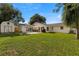 Spacious backyard with patio area, fire pit, and storage shed at 4208 W Bay Vista Ave, Tampa, FL 33611