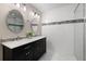 A stylish bathroom features a double vanity and glass shower at 4208 W Bay Vista Ave, Tampa, FL 33611
