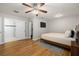 This bedroom has a ceiling fan, closet, wood floors, and natural light at 4208 W Bay Vista Ave, Tampa, FL 33611