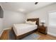 This airy bedroom has a ceiling fan, wood floors, and a large window at 4208 W Bay Vista Ave, Tampa, FL 33611