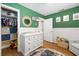 Adorable Bedroom with a changing table, closet and toys for baby at 4208 W Bay Vista Ave, Tampa, FL 33611