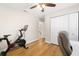 Bedroom has a ceiling fan, wood floors, and an exercise bike, offering both relaxation and fitness at 4208 W Bay Vista Ave, Tampa, FL 33611