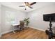 Bright bedroom offers natural light, a ceiling fan, and a dedicated space for a desk and exercise equipment at 4208 W Bay Vista Ave, Tampa, FL 33611