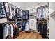 Large walk-in closet with custom shelving and wood floors at 4208 W Bay Vista Ave, Tampa, FL 33611