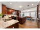 This kitchen features wood cabinets, granite countertops, stainless steel appliances, and an island with a dining area at 4208 W Bay Vista Ave, Tampa, FL 33611