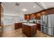 Spacious kitchen featuring dark wood cabinetry, stainless steel appliances, and center island with granite countertops at 4208 W Bay Vista Ave, Tampa, FL 33611
