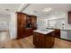 Spacious kitchen features custom wood cabinetry, stainless appliances, and a center island with a marble countertop at 4208 W Bay Vista Ave, Tampa, FL 33611