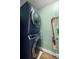 This laundry room features a stacked washer and dryer and storage for cleaning supplies at 4208 W Bay Vista Ave, Tampa, FL 33611
