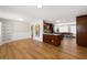 Open-concept living area boasts wood floors, wainscoting, and a seamless flow to the kitchen with granite countertops at 4208 W Bay Vista Ave, Tampa, FL 33611