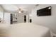 Spacious main bedroom with en-suite bathroom, vanity area, ceiling fan, and mounted television at 4208 W Bay Vista Ave, Tampa, FL 33611