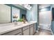 Bathroom with a double sink vanity, modern fixtures, and a well-lit mirror, offering a luxurious feel at 4286 Cairoli Ct, Wesley Chapel, FL 33543