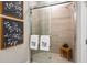 Modern bathroom featuring a glass-enclosed shower with elegant tile and decorative towels at 4286 Cairoli Ct, Wesley Chapel, FL 33543