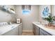 Efficient laundry room with modern washer and dryer, ample counter space, and a bright window at 4286 Cairoli Ct, Wesley Chapel, FL 33543