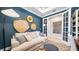 Inviting living area with a comfortable sofa, decorative wall art, and elegant French doors at 4286 Cairoli Ct, Wesley Chapel, FL 33543