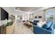 Open-concept living area with stylish furniture, tile floors, and natural light at 4286 Cairoli Ct, Wesley Chapel, FL 33543
