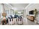 Modern living room with large windows, tray ceiling, and contemporary furnishings at 4286 Cairoli Ct, Wesley Chapel, FL 33543