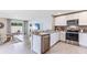 Modern kitchen featuring stainless steel appliances, granite countertops, and a breakfast bar at 4362 Sand Dollar Way, Zephyrhills, FL 33541