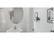 Powder room featuring a stylish mirror and sink, and decorated walls at 4381 Sand Dollar Way, Zephyrhills, FL 33541