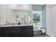 Bright bathroom features double sinks, dark cabinetry, a large mirror, and shower with patterned curtain at 4381 Sand Dollar Way, Zephyrhills, FL 33541
