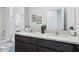 Modern bathroom featuring double sinks, dark cabinets, granite countertop, and shower/tub combo at 4381 Sand Dollar Way, Zephyrhills, FL 33541