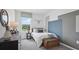 Stylish bedroom featuring a single bed, a dresser, a window, and a blue accent wall at 4381 Sand Dollar Way, Zephyrhills, FL 33541