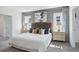 Comfortable bedroom with large bed, decorative pillows, bedside tables, lamps, and complementing curtains at 4381 Sand Dollar Way, Zephyrhills, FL 33541