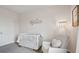 Cozy Bedroom with white crib, chair, decorative wall art, and carpeted floor at 4381 Sand Dollar Way, Zephyrhills, FL 33541