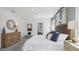 Well-lit bedroom with neutral tones, stylish furniture, a king bed, and complementary decor at 4381 Sand Dollar Way, Zephyrhills, FL 33541