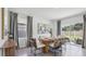 Elegant dining area features a stylish table with seating and sliding glass doors to the backyard at 4381 Sand Dollar Way, Zephyrhills, FL 33541