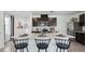 Well-lit kitchen boasts a center island, dark wood cabinetry, stainless steel appliances and neutral countertops at 4381 Sand Dollar Way, Zephyrhills, FL 33541