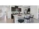 Spacious kitchen features a center island with seating, dark cabinetry and stainless steel appliances at 4381 Sand Dollar Way, Zephyrhills, FL 33541