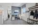 Well-lit home office with a desk, a rolling chair, a window and a coat rack at 4381 Sand Dollar Way, Zephyrhills, FL 33541