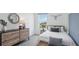 Bright bedroom features a bed, modern dresser, large window, and nature decor at 4401 Sand Dollar Way, Zephyrhills, FL 33541