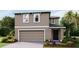 New two-story home featuring a two-car garage, neutral color palette and manicured front yard at 4401 Sand Dollar Way, Zephyrhills, FL 33541