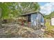 Spacious backyard with mature trees, a patio area, and a utility sink at 4801 71St N St, St Petersburg, FL 33709