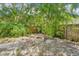 Secluded backyard featuring a brick fire pit and lush tropical landscaping at 4801 71St N St, St Petersburg, FL 33709
