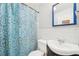 A full bathroom featuring white tile walls, modern fixtures, and a patterned shower curtain at 4801 71St N St, St Petersburg, FL 33709