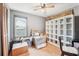 Bedroom featuring an open window, laminate floors, a ceiling fan and a storage shelf at 4801 71St N St, St Petersburg, FL 33709