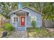 Charming single-story home featuring a bright red front door and inviting front porch at 4801 71St N St, St Petersburg, FL 33709