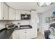 Kitchen with white cabinets, black countertops, stainless steel appliances and tile floor at 4801 71St N St, St Petersburg, FL 33709