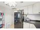 Kitchen with black refrigerator and countertops, white cabinets and a view of shelving at 4801 71St N St, St Petersburg, FL 33709