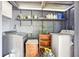 Functional laundry area featuring a washer, dryer, shelving, and storage space at 4801 71St N St, St Petersburg, FL 33709