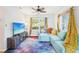 Bright living room with unique galaxy carpet, a comfortable blue sofa and lots of natural light at 4801 71St N St, St Petersburg, FL 33709